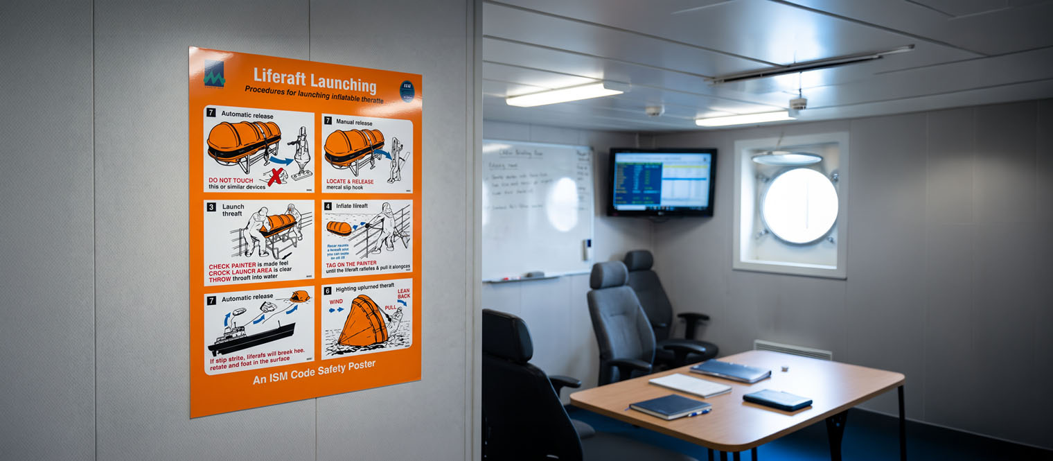 A safety or training poster displayed in a crew briefing room or working area aboard a vessel.